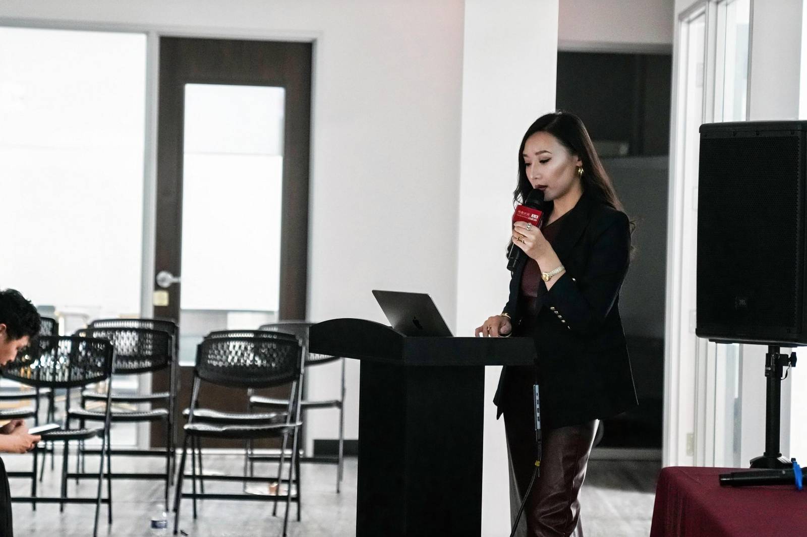 Laura speaking at a professional event